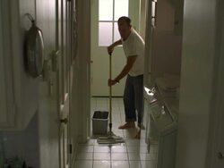 WS, Man mopping tile floor in laundry room, Hollywood, California, USA Stock Footage