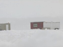 MS View of ice fishing houses and trailer on lake during winter / Minneapolis, Minnesota, USA Stock Footage