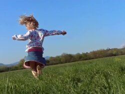 HD Super Slow-Mo: Little Girl Twirling In The Grass Stock Footage