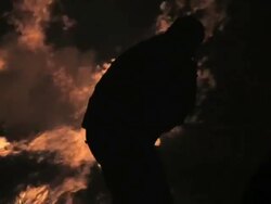 M-L/S Silhouette man feeding a bonfire Stock Footage