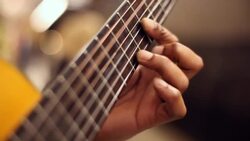 Skilled hands play acoustic guitar on New York City subway platform Stock Footage