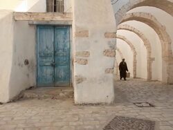 Old man walking in olg Djerba Stock Footage