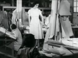 B/W 1934 women being fitted in dress in WPA garment factory / documentary Stock Footage