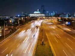 WS T/L Traffic moving on Express Way behind National Assembly in Yeouido Business District / Seoul, South Korea Stock Footage
