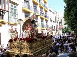 People following the Costaleros bearing a Trono in a procession through the streets of Malaga, Andalucia, Spain, Europe Stock Footage