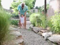 MS Shot of mother and baby walking through garden / St Simon's Island, Georgia, United States Stock Footage