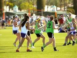 SLO MO high school lacrosse girls begin ball play with face-off then run with their lacrosse stick to catch carry and pass the ball  / Indio, California, USA  Stock Footage