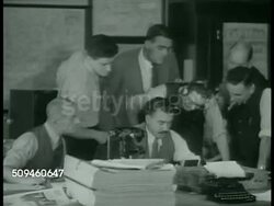 1938: LONDON, ENGLAND: WS EXT Daily Express newspaper building. INT Office w/ men gathering around male sitting at desk. CU Dispatch from Prague saying situation in Prague unchanged, hoping no military invasion. Male standing by window reading paper. Instructional Video