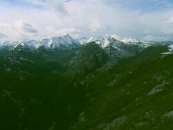 High altitude wide shot of the snow-capped Spanish Peaks mountain range near Big Sky, MT Stock Footage