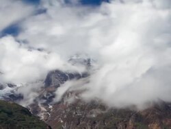 Panning shot of Time-lapse of clouds moving around Himalayan mountains. Stock Footage
