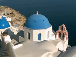MS Shot of village Oia with church and Ocean / Santorini, Cyclades, Greece Stock Footage