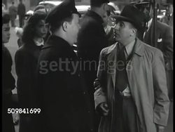 1946: DRAMATIZATION: Male trying to enter crime scene building, stereotypical Irish policeman stopping him, man saying he has to get in, some guy was murdered, policeman asking what that has to do with him, man saying he wants to rent the apartment. Instructional Video