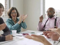  CU PAN Laughing and clapping at business meeting / New York, USA Stock Footage