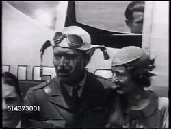 1933: AERONAUTICAL RACING: Aviator Colonel Roscoe Turner w/ brunette (believed to be wife Margaret Miller), VS Roscoe w/ 'Gilmore' cub, showing face, SOT growling. [VO Roscoe saying wanted to be different, Gilmore Oil lion logo, adopted cub, takes eve Instructional Video