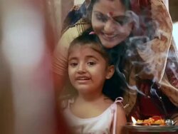Woman praying with her daughter in the temple  Stock Footage