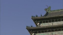A blue sky outlines a pagoda roof with a dragon motif in Beijing, China. Stock Footage