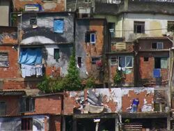 MS Man ripping papers on to red brick  / Lagos, Nigeria Stock Footage