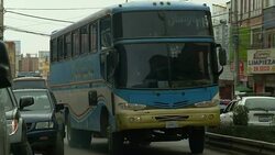 A bus slowly pulls onto a city street. Stock Footage