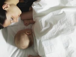 mother and baby asleep in bed Stock Footage