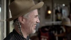 Friendly shop owner laughs with customers in Texas ghost town Stock Footage