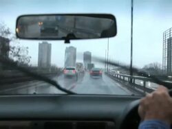 Driving on a rainy wet day with poor visibility and spray on the elevated section of the M4 Motorway, near to Chiswick in west London. Stock Footage