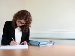Female Spanish lawyer signing documents Stock Footage