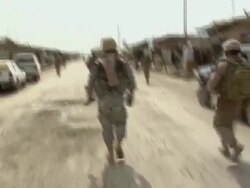 WS POV PAN Soldiers walking on dirt road / Musa Qala, Helmand Province, Afghanistan. Stock Footage
