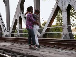 MS Young male and female couple hanging out on train track outside in urban area together having fun and smiling / Minneapolis, Minnesota, United States Stock Footage