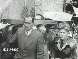 MOT 1946:PALESTINE: CHRISTIANS: VS People carrying large wooden cross up Jerusalem city stairs (toward hill of execution). CAVERY / GOLGOTHA: VS Inside religious shrine w/ priests, alter boys, woman holding candle while kissing floor, touching metal sun. Instructional Video