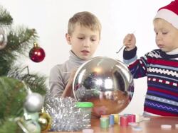 children paint the Christmas toys Stock Footage