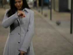 TU MS Young woman checking time as young man arriving to meet her at night / China Stock Footage