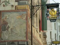 LS traditional ensigns and frescoes in city center Stock Footage