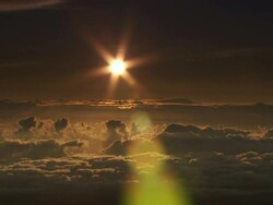 Wide Shot static - A sunburst shines over a sea of clouds at Mauna Kea, Hawaii. / Mauna Kea, Hawaii, USA Stock Footage