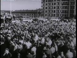 General Charles de Gaulle waves from a convertible in a motorcade in Algiers, Algeria following riots demanding his return to power. News Clip