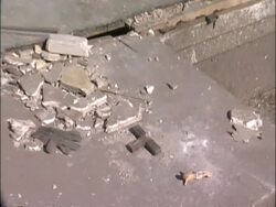 MS Tornado damage - Broken crucifix, tilt up wrecked house, pan to lorry carrying some of debris, wrecked car and debris to horizon, USA Stock Footage