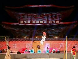 MS View of Some people performing tightrope walking with paper fan andothers playing Korean traditional musical instruments against Heungnyemun gate(Traditional Korean Architecture) of Kyongbokkung Palace AUDIO / Seoul, South Korea Stock Footage