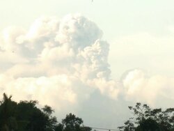 Wide shot of major eruption at Merapi volcano shooting large ash cloud high into the sky; Indonesia. 7 November 2010 / AUDIO Stock Footage