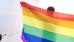 Beautiful young adult female spinning holding gay pride flag Stock Footage