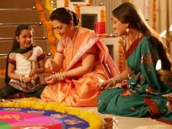Family preparing rangoli in diwali festival Stock Footage
