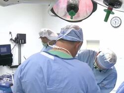 Doctors in operating room performing surgery Stock Footage