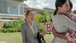 Enthusiastic couple receiving keys from realtor in front of house Stock Footage