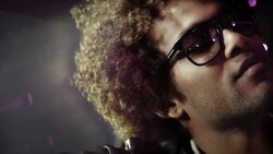 Hip-hop star smiles smugly in limousine while cameras flash outside at awards show Stock Footage