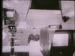 1963: UNITED STATES AIR FORCE ACADEMY: VS Instructor talking (no SOT) in front of camera in studio, broadcasting lesson. Colorado, Co, Rampart Range, closed circuit television Instructional Video