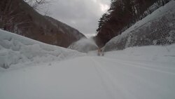 pass a snowplow at snow mountain road -4K- Stock Footage