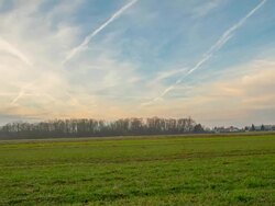 HD Motion Time-Lapse: Cloudscape Over A Meadow And Village Stock Footage