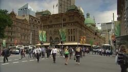Business professionals cross Druitt Street near Queen Victoria Building in Sydney, Australia. Stock Footage