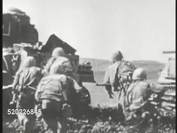 1945: OKINAWA, JAPAN: US SIXTH MARINE DIVISION: US Marines on top of hill. Tank Infantry Marines walking behind moving tank. WS Valley w/ tank on fire, white bomb explosion, tank burning. Pacific Theater, WWII, World War II. Instructional Video