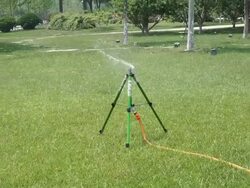 springkler watering park lawn at daytime Stock Footage
