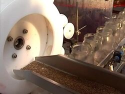 Glass jar and caraway spice on conveyor line Stock Footage