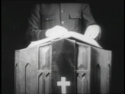 A Salvation Army minister turns pages in a Bible until he finds the scripture he wants. News Clip